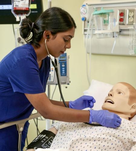 Holy Family University nursing student working in the simulated patient lab